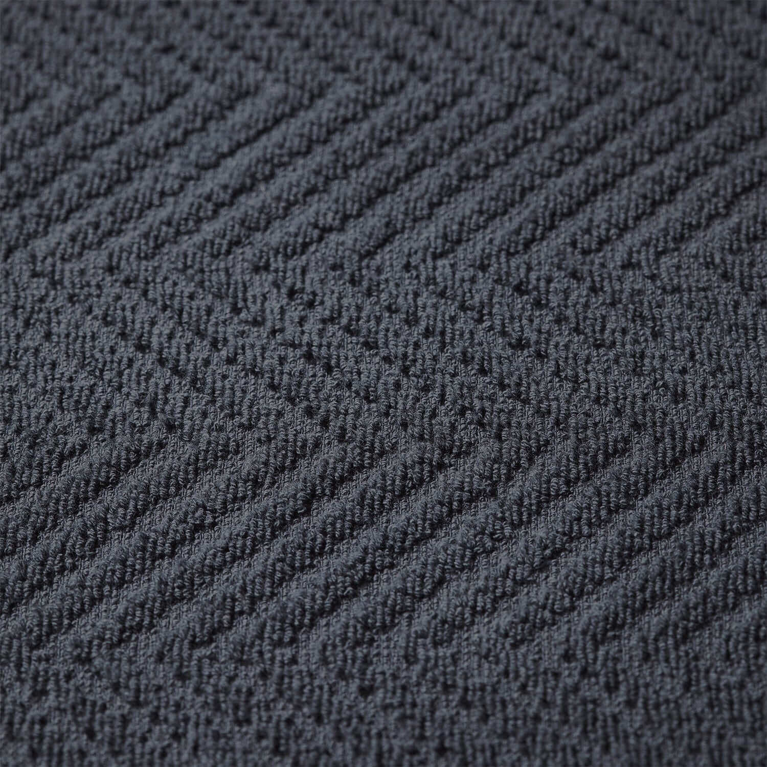 Treatment towel in slate gray with a textured herringbone pattern, ideal for spa and wellness environments.