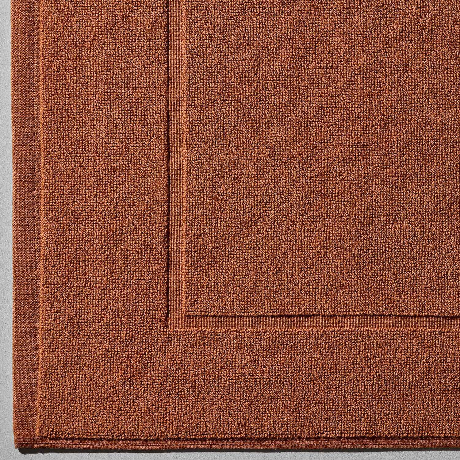 Close-up of a clay treatment mat in a warm Bruno color, textured for safe footing and mud treatment use.