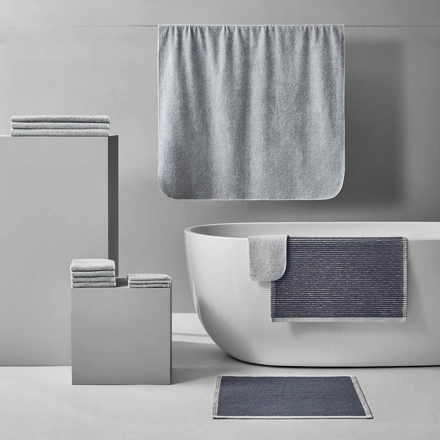 Tuxedo Bath Bundle Gray showcasing eco-luxury towels in a modern bathroom setting with a freestanding tub.