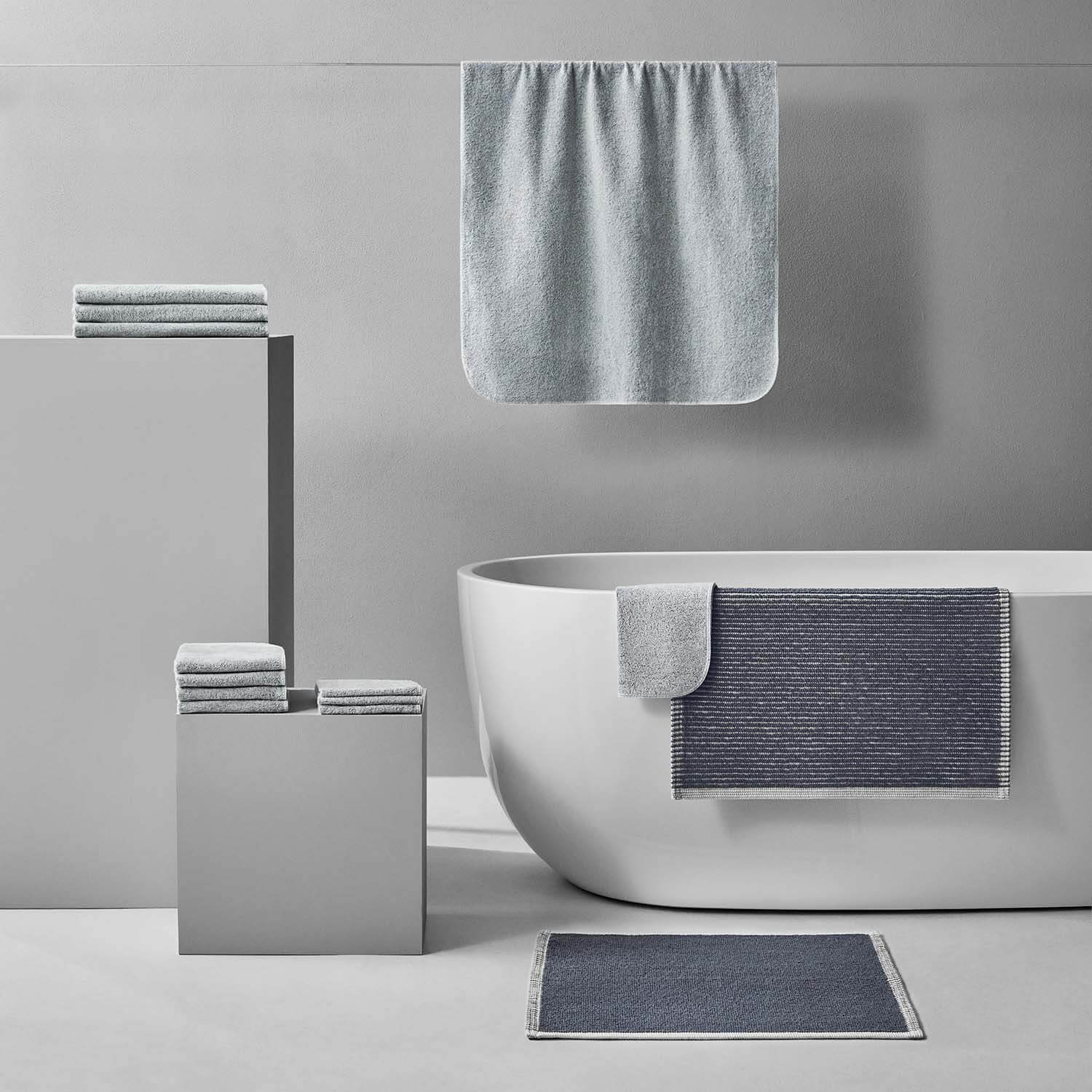 Tuxedo Bath Bundle in gray, featuring sustainably sourced cotton towels and bath mats in a stylish modern bathroom setting.