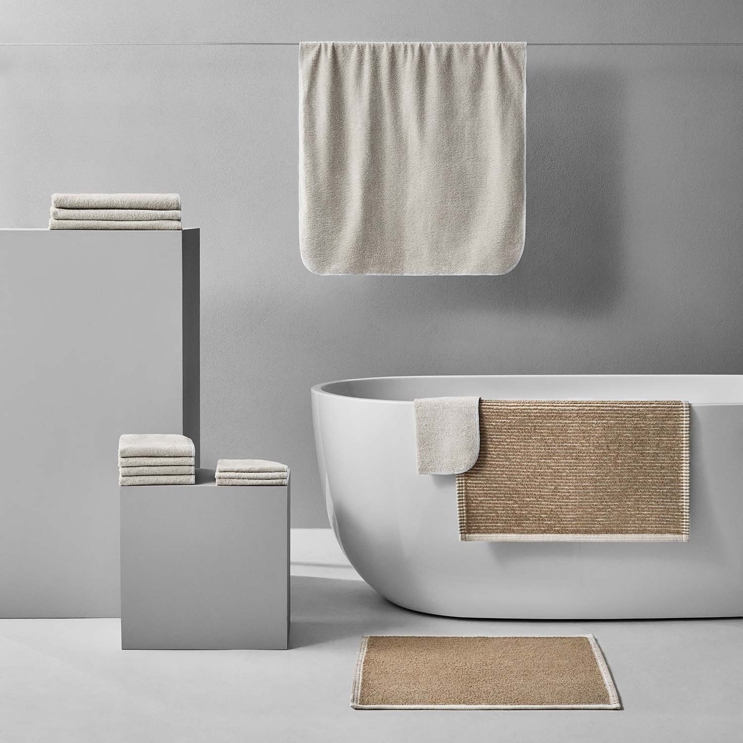 Tuxedo Bath Bundle in Sand, featuring eco-luxury towels and mats, showcasing sustainable Brazilian cotton in modern bathroom setting.