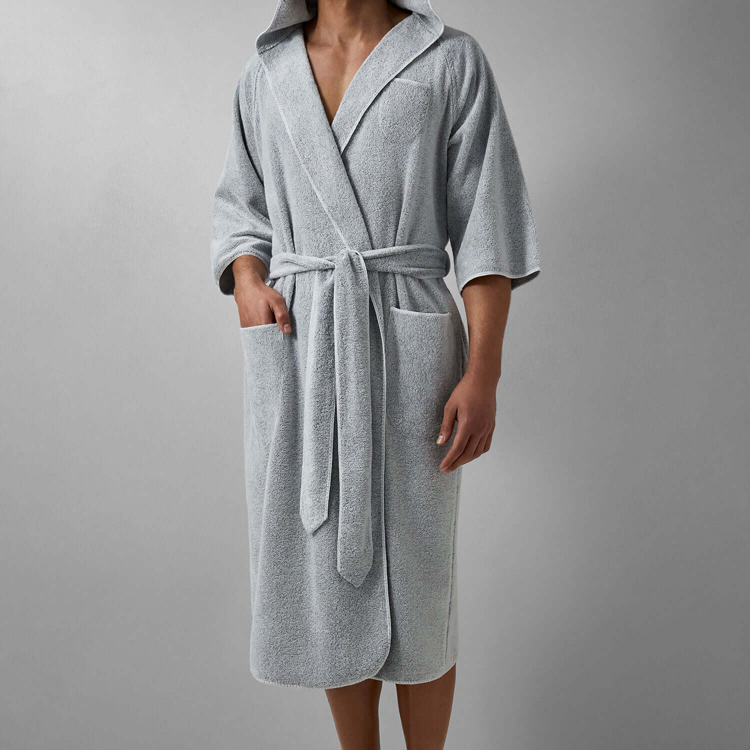 Hooded gray tuxedo robe with softly rounded finishes, self-tie belt, and pockets for a chic unisex look.