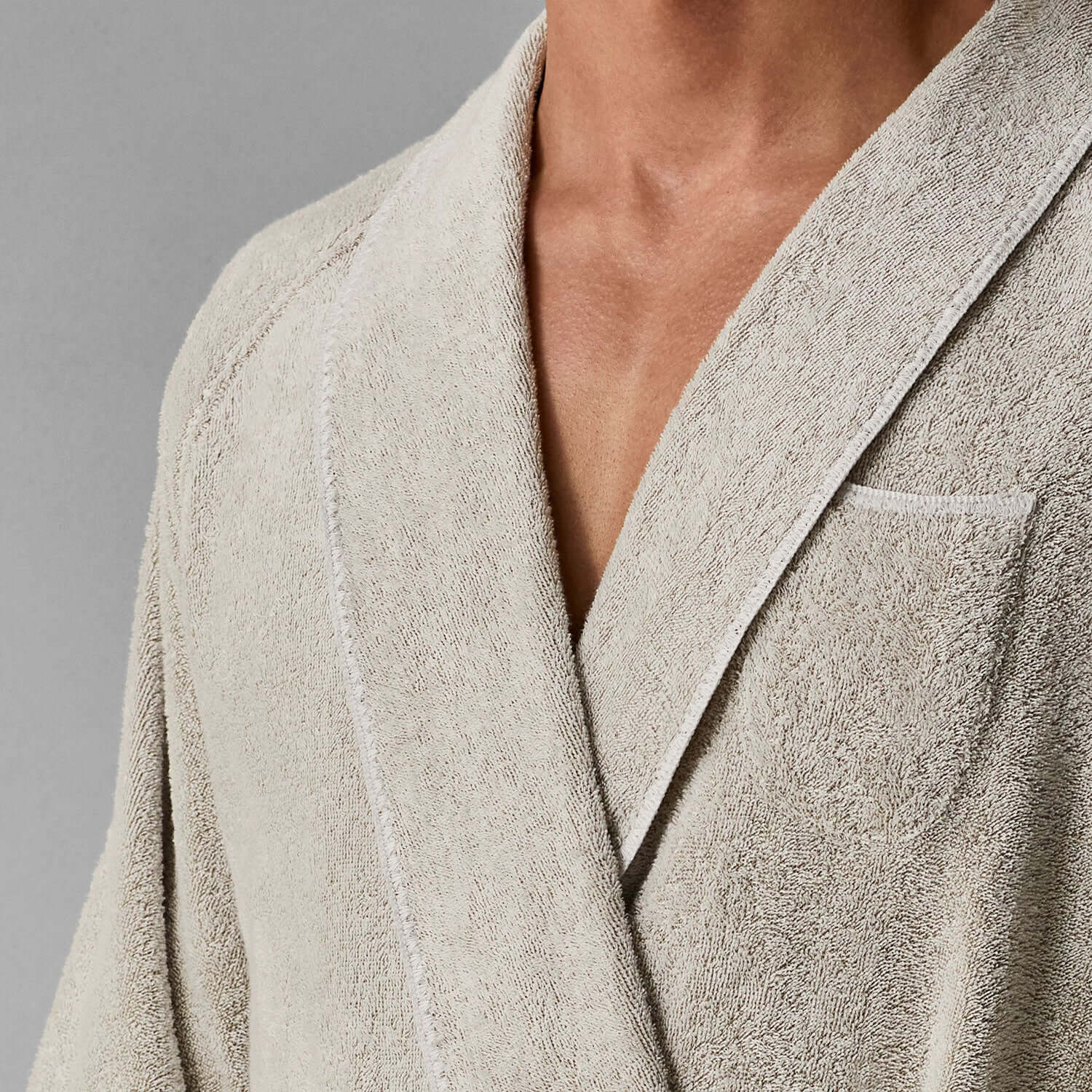 Close-up of Tuxedo Shawl Sand robe featuring a sleek design and textured fabric in a neutral tone.