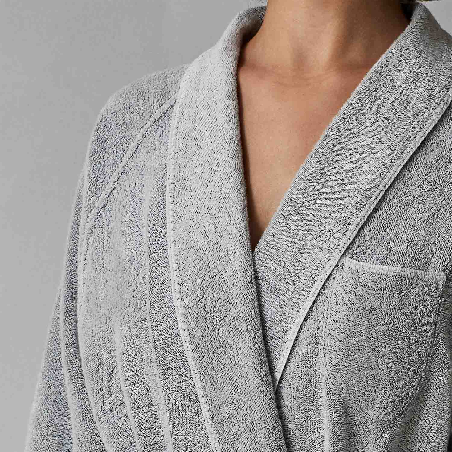 Close-up of a gray tuxedo shawl robe featuring a soft texture, elegant rounded finishes, and a pocket.