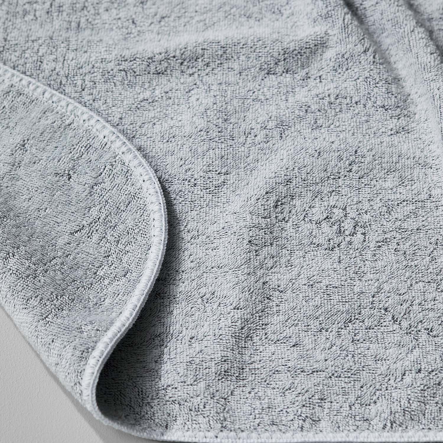 Close-up of a soft gray towel from the Tuxedo Collection, showcasing its luxurious texture and multi-tonal hues.