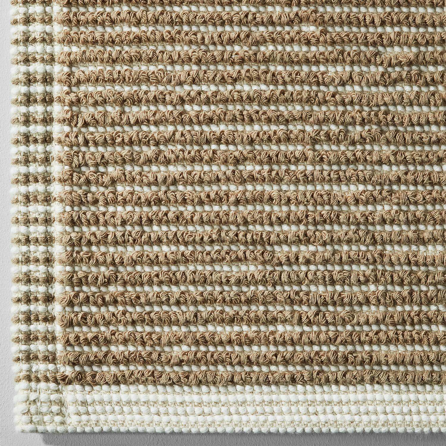 Tuxedo Mat Sand featuring a grey stripe pattern woven in a modern square shape, ideal for sinks and showers.