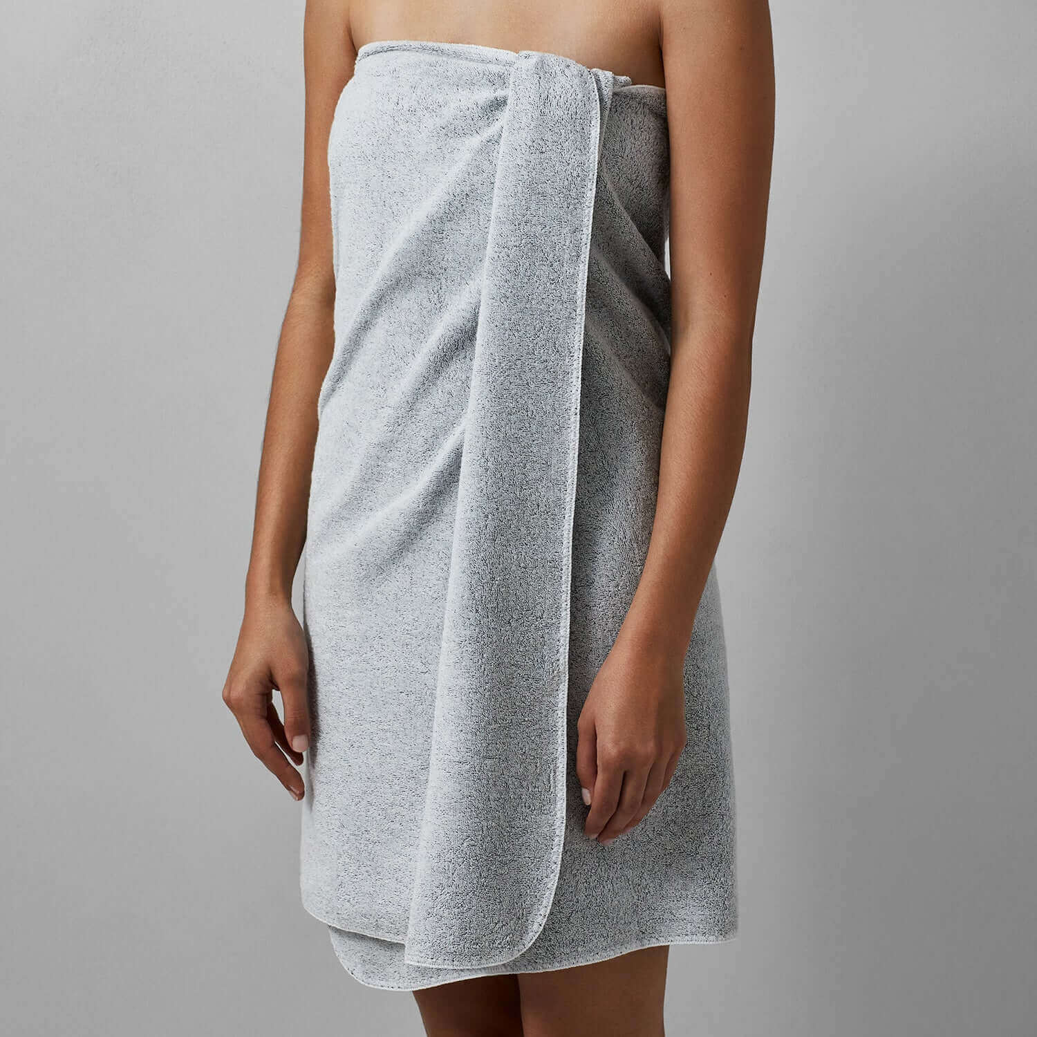 Model wearing Tuxedo Towel in Millennial Grey, featuring multi-tonal hues, perfect for wholesale options.
