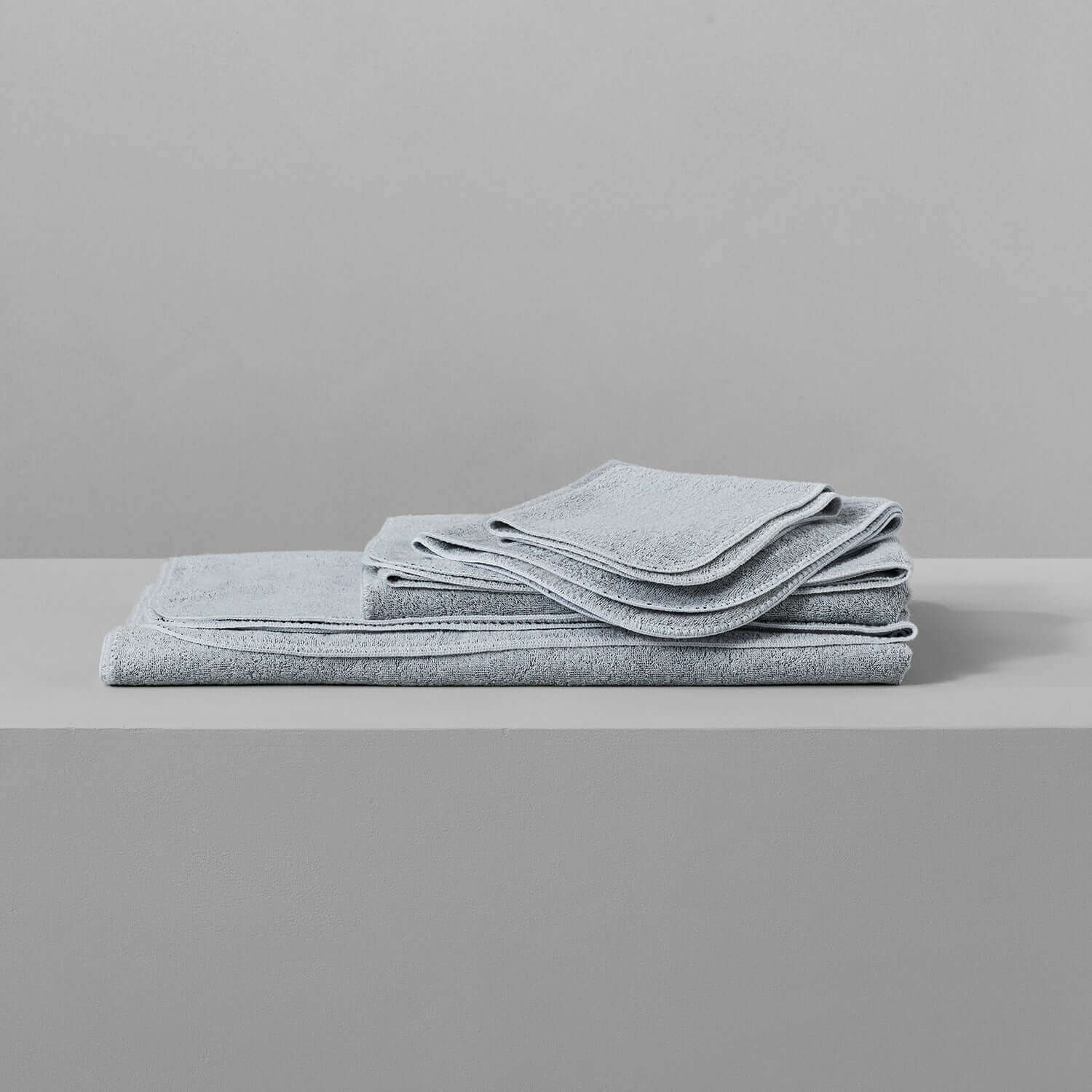 Gray Tuxedo towels stacked, showcasing multi-tonal hues suitable for wholesale, chlorine-compatible, enduring vibrant colors.
