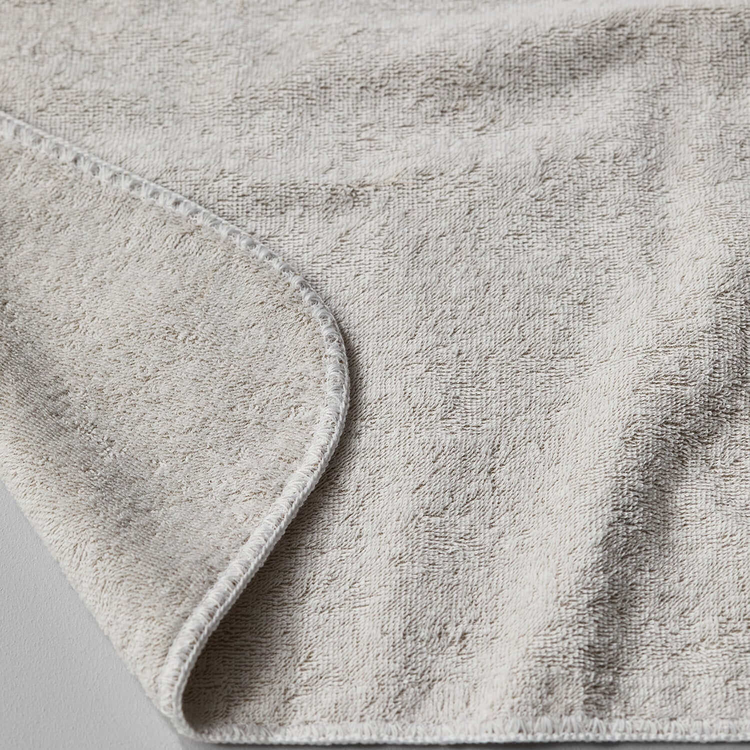 Close-up of the Tuxedo Towel in Sand, showcasing its soft texture and durable, chlorine-compatible fabric.