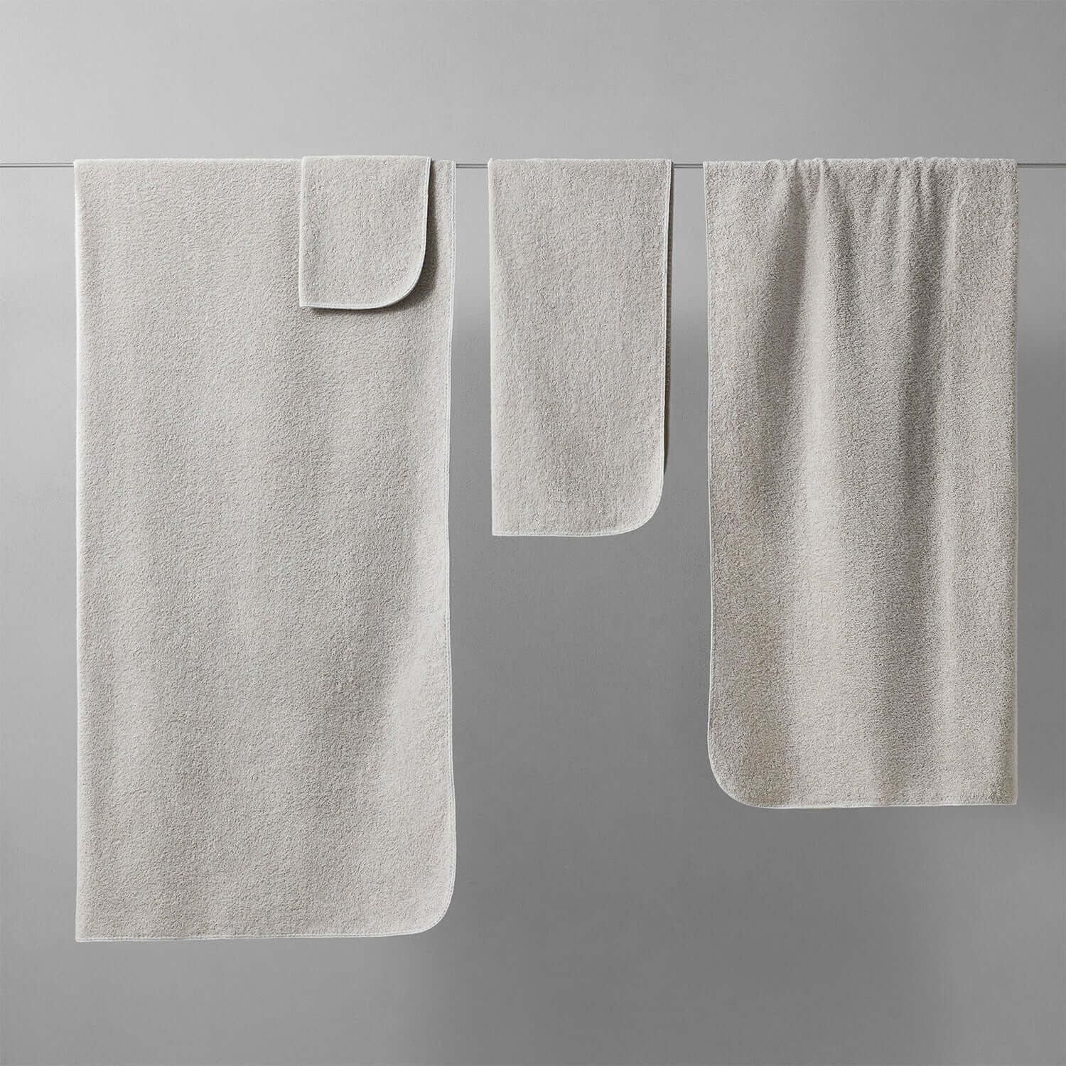 Tuxedo Towel Collection in Millennial Grey, showcasing multi-tonal hues and chlorine-compatible fabric.