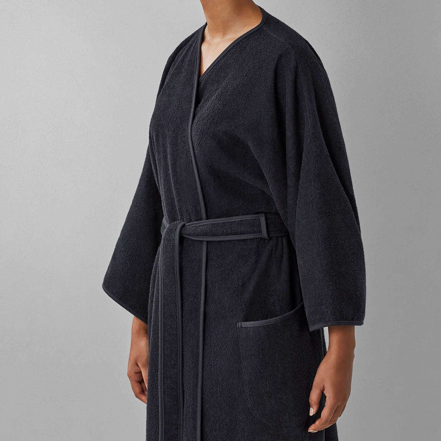 Wabi Sabi black robe showcasing minimalist design, embodying luxury and sustainability in a tranquil, imperfect style.