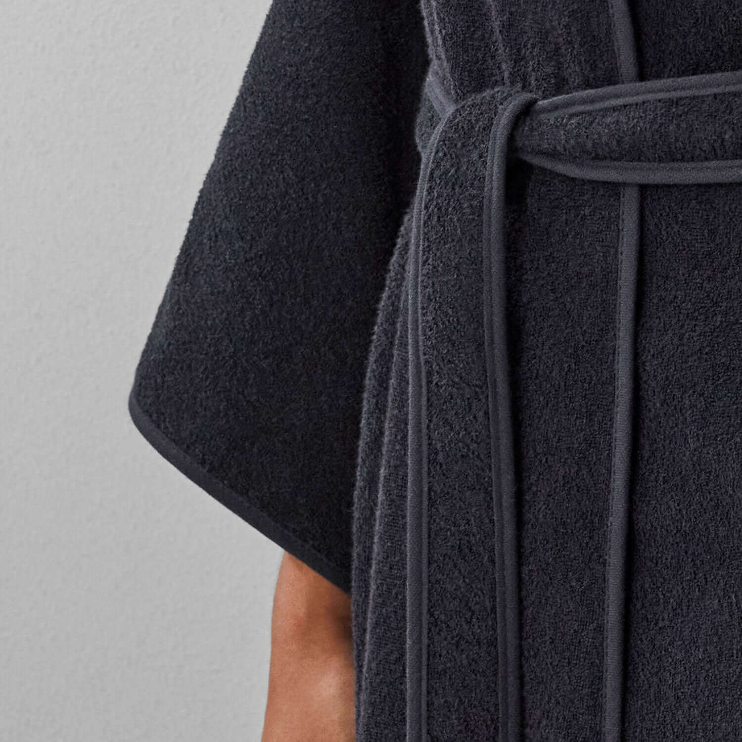 Close-up of a black Wabi Sabi robe showcasing soft fabric and minimalist design, emphasizing luxury and sustainability.