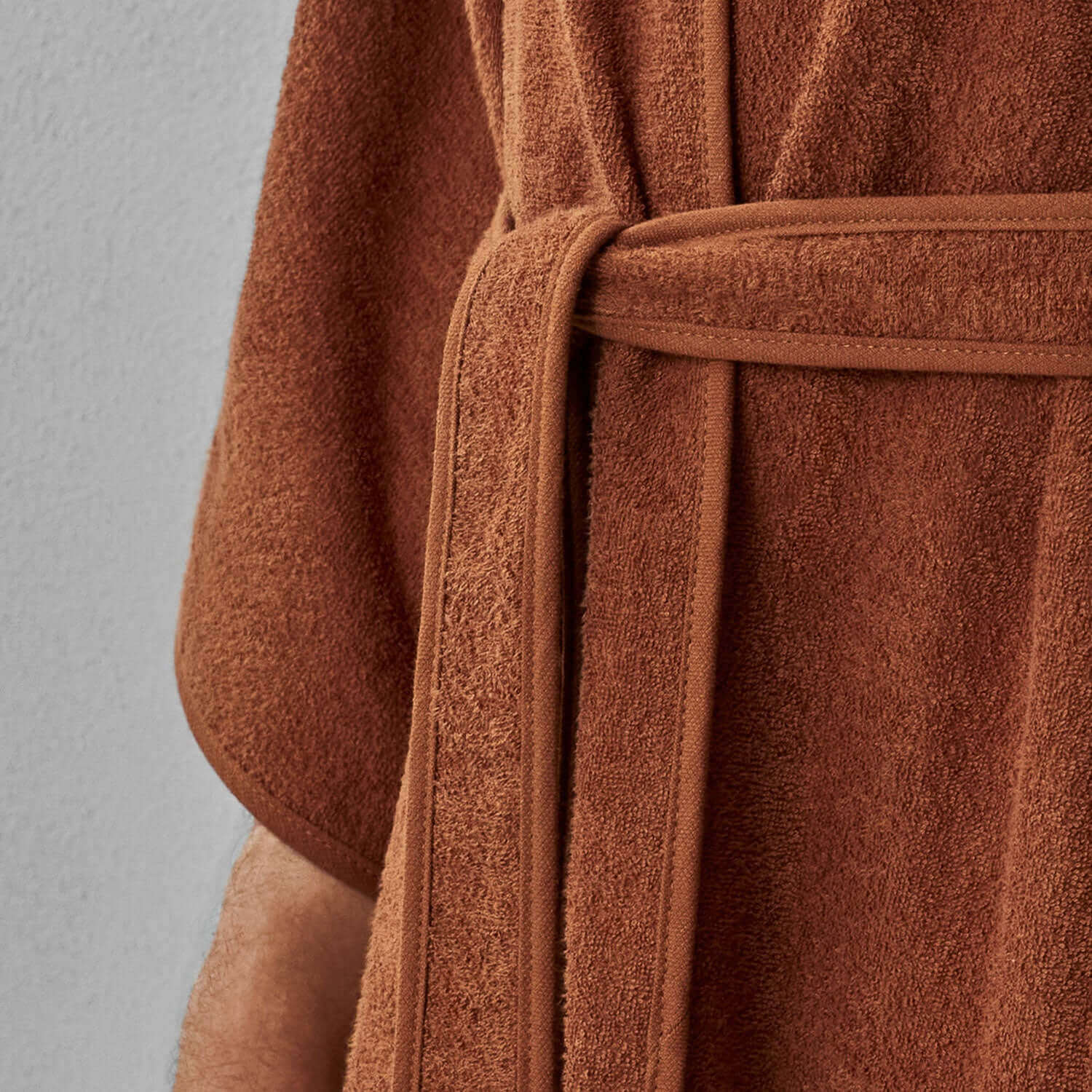 Wabi Sabi robe in copper with a tie belt, showcasing minimalist design and luxurious texture.