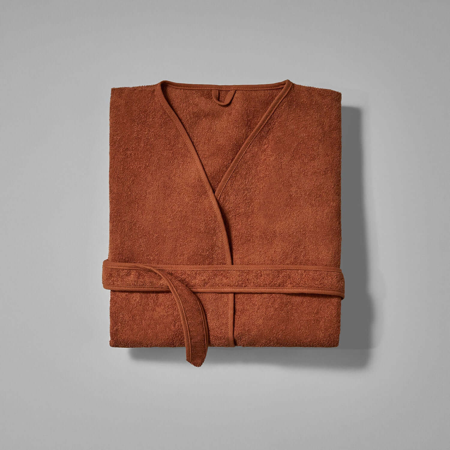 Wabi Sabi robe in copper color, showcasing minimalist design and the beauty of imperfection.