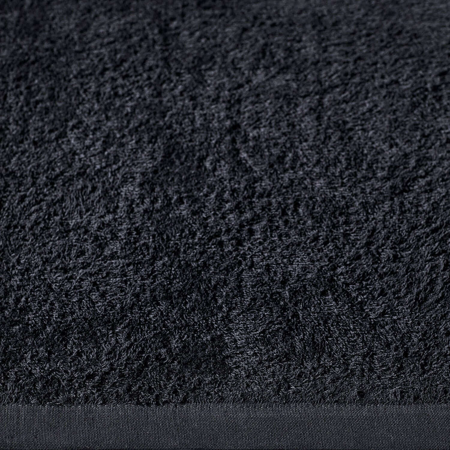 Wabi Sabi black towel showcasing minimalist texture and design, embodying luxury and sustainable craftsmanship.