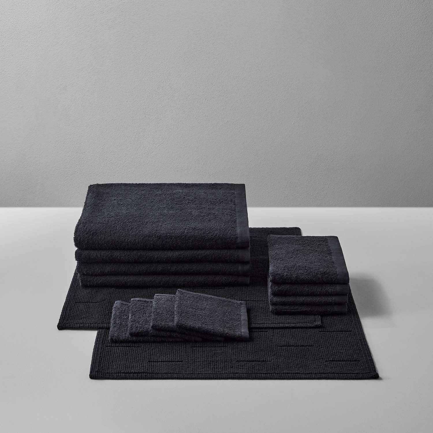 Wabi Sabi Bath Bundle in Black featuring luxurious towels and mats, embodying minimalist design and sustainable craftsmanship.