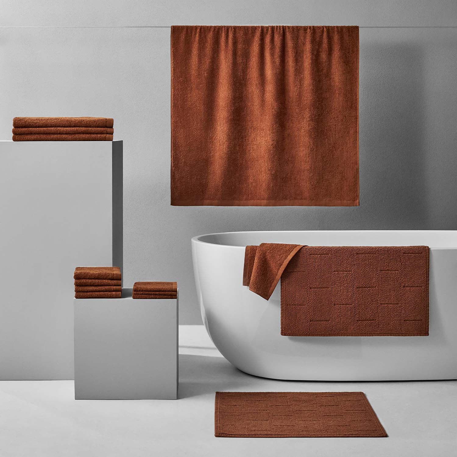 Wabi Sabi Bath Bundle Copper featuring warm brown towels and bath mat in a minimalist bathroom setting.