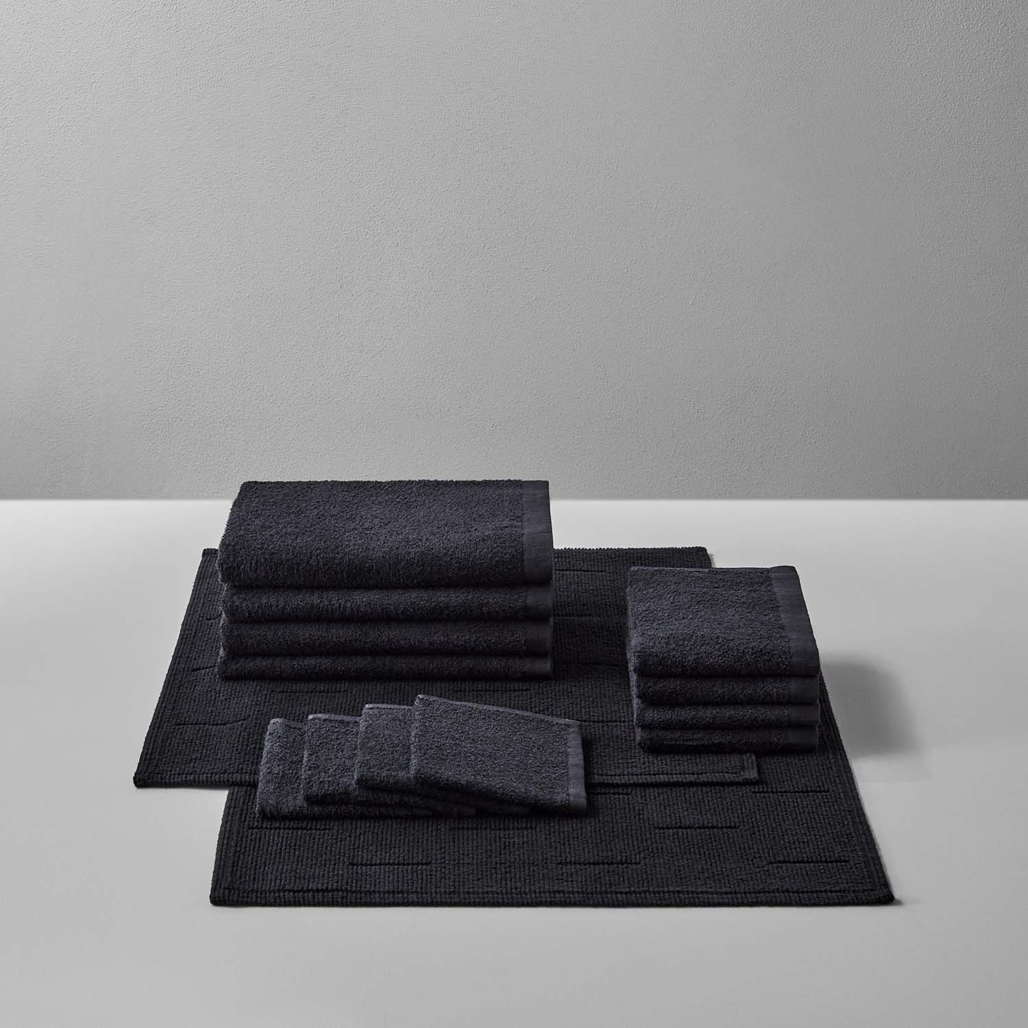 Wabi Sabi Bath Bundle in black, featuring luxurious towels and mats for a minimalist bathroom aesthetic.