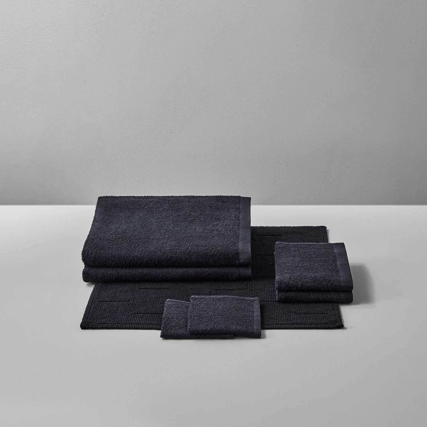 Wabi Sabi Bath Bundle in Black featuring luxurious towels and mats, embodying minimalist design and sustainable craftsmanship.