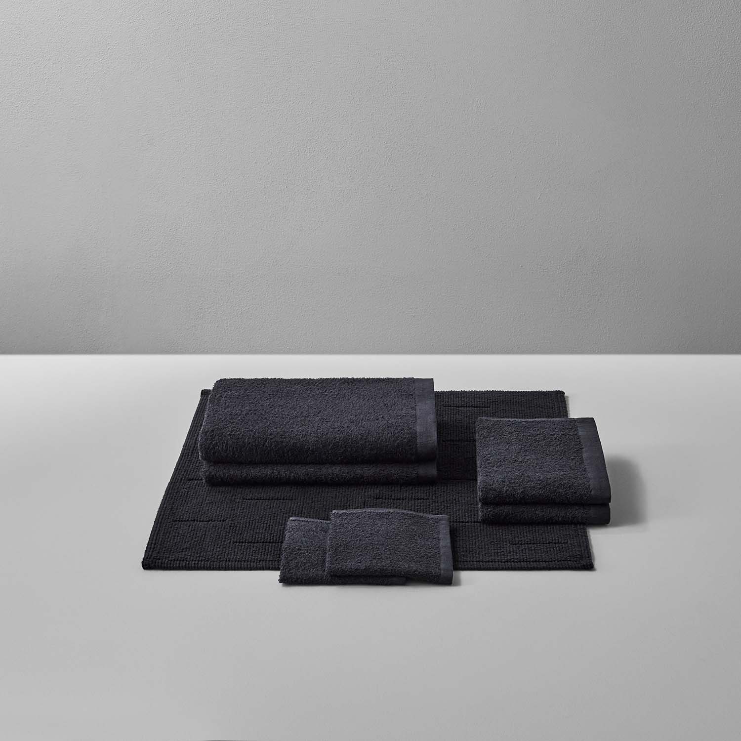 Wabi Sabi Bath Bundle in Black, showcasing minimalist towels and mats for a luxurious and sustainable bathroom experience.