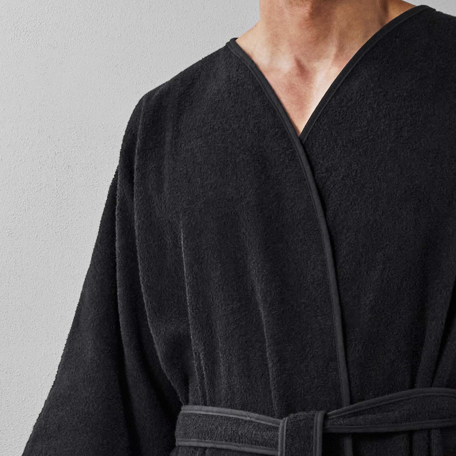 Wabi Sabi black robe showcasing minimalist design and luxurious texture, emphasizing tranquility and timeless craftsmanship.