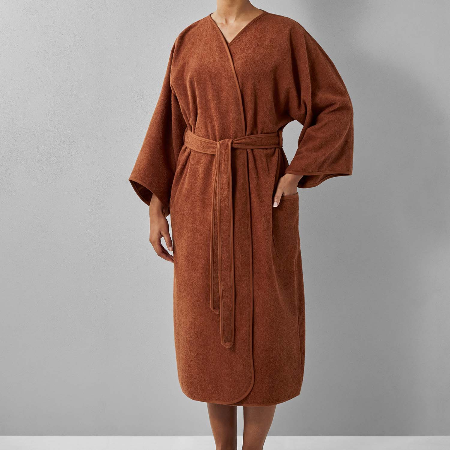 Wabi Sabi robe in copper color, showcasing minimalist design and sustainable luxury craftsmanship.