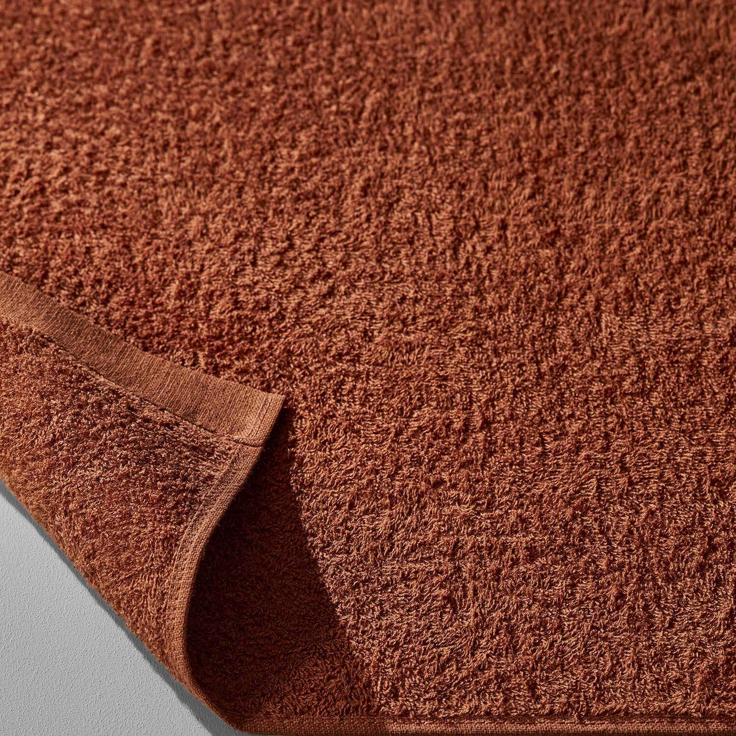 Wabi Sabi Towel in copper color showcasing texture and minimalist design for a luxurious and sustainable experience.