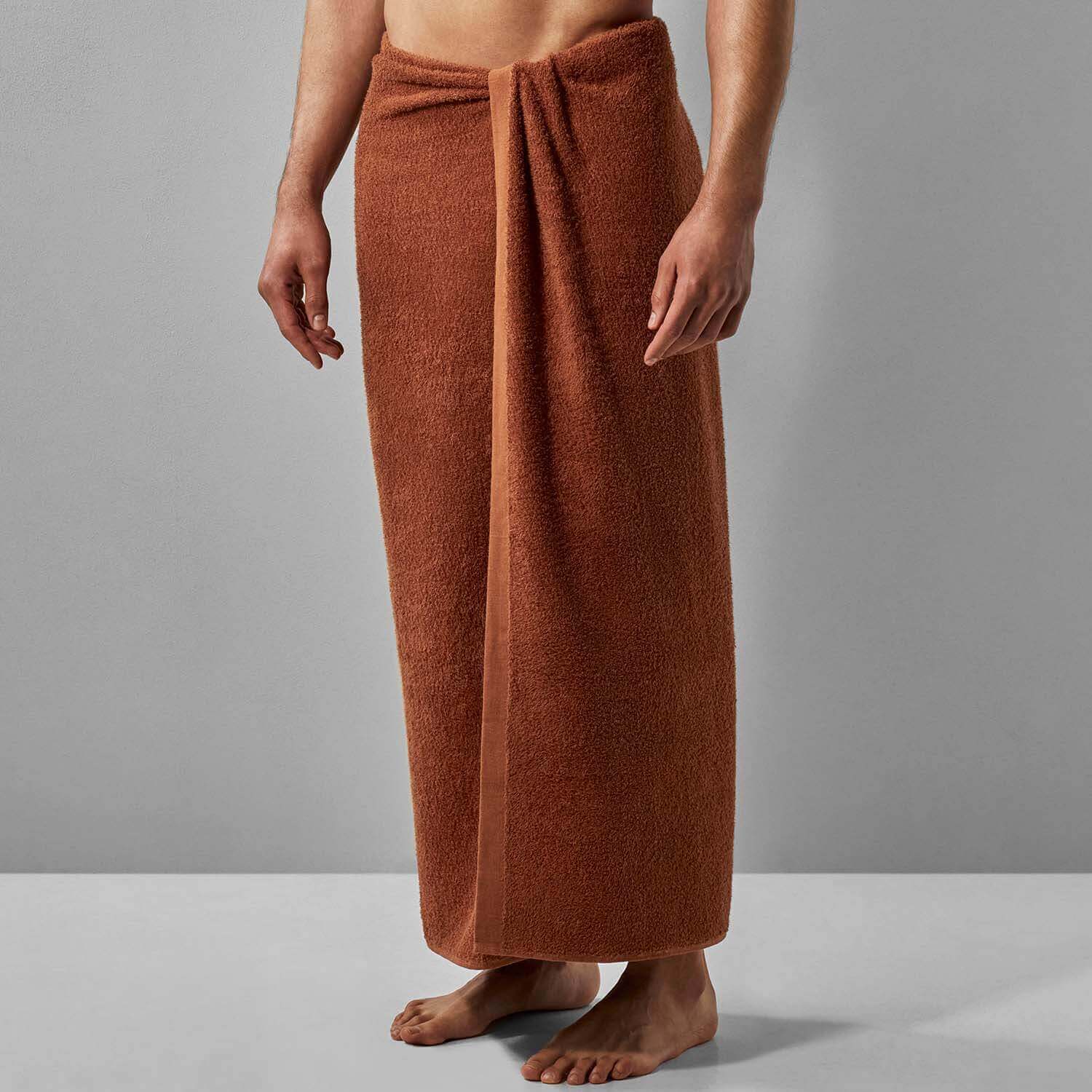 A person wearing a Wabi Sabi Copper towel, showcasing minimalist design and sustainable luxury.