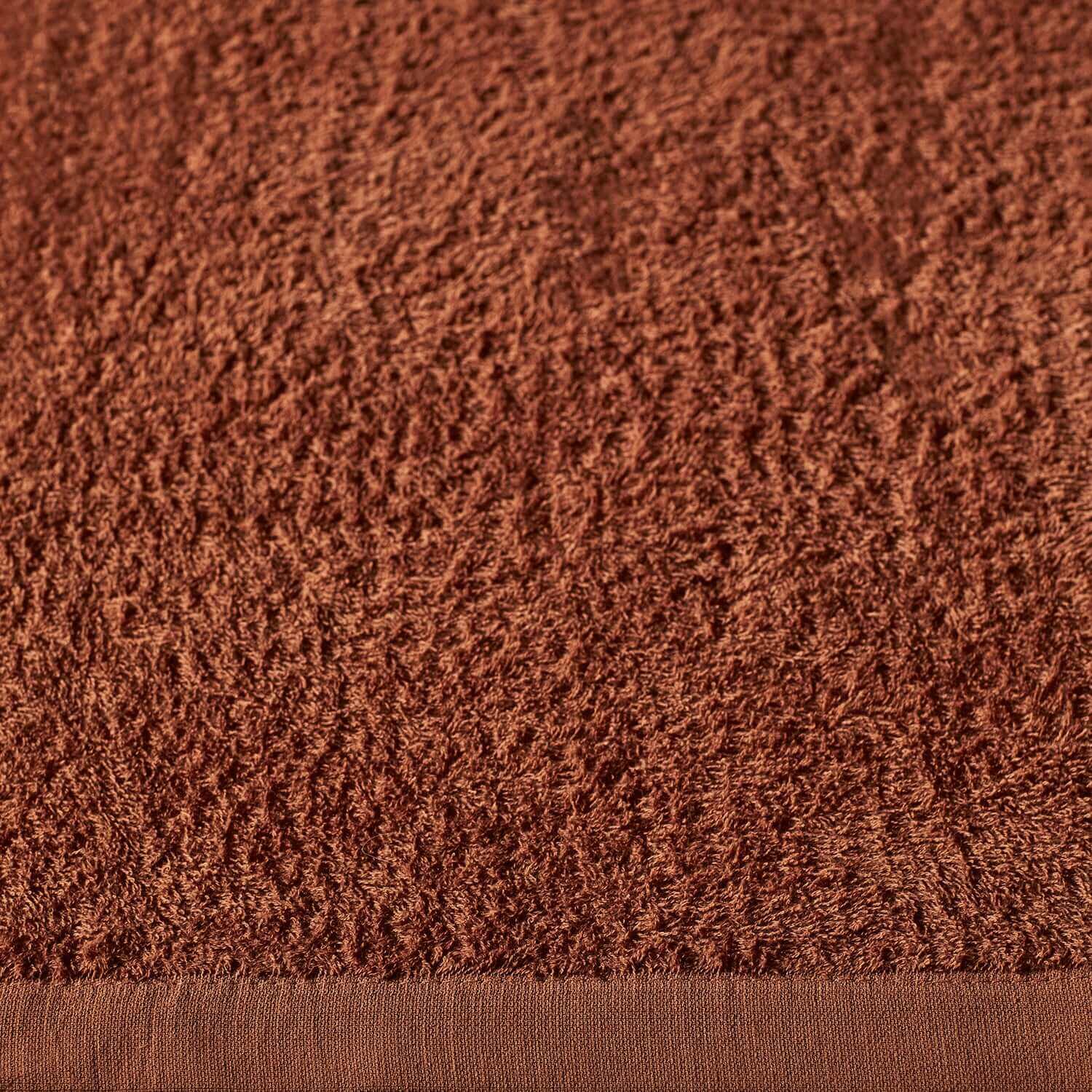 Close-up of a Wabi Sabi towel in rich copper color, showcasing its soft texture and minimalist design for sustainable luxury.