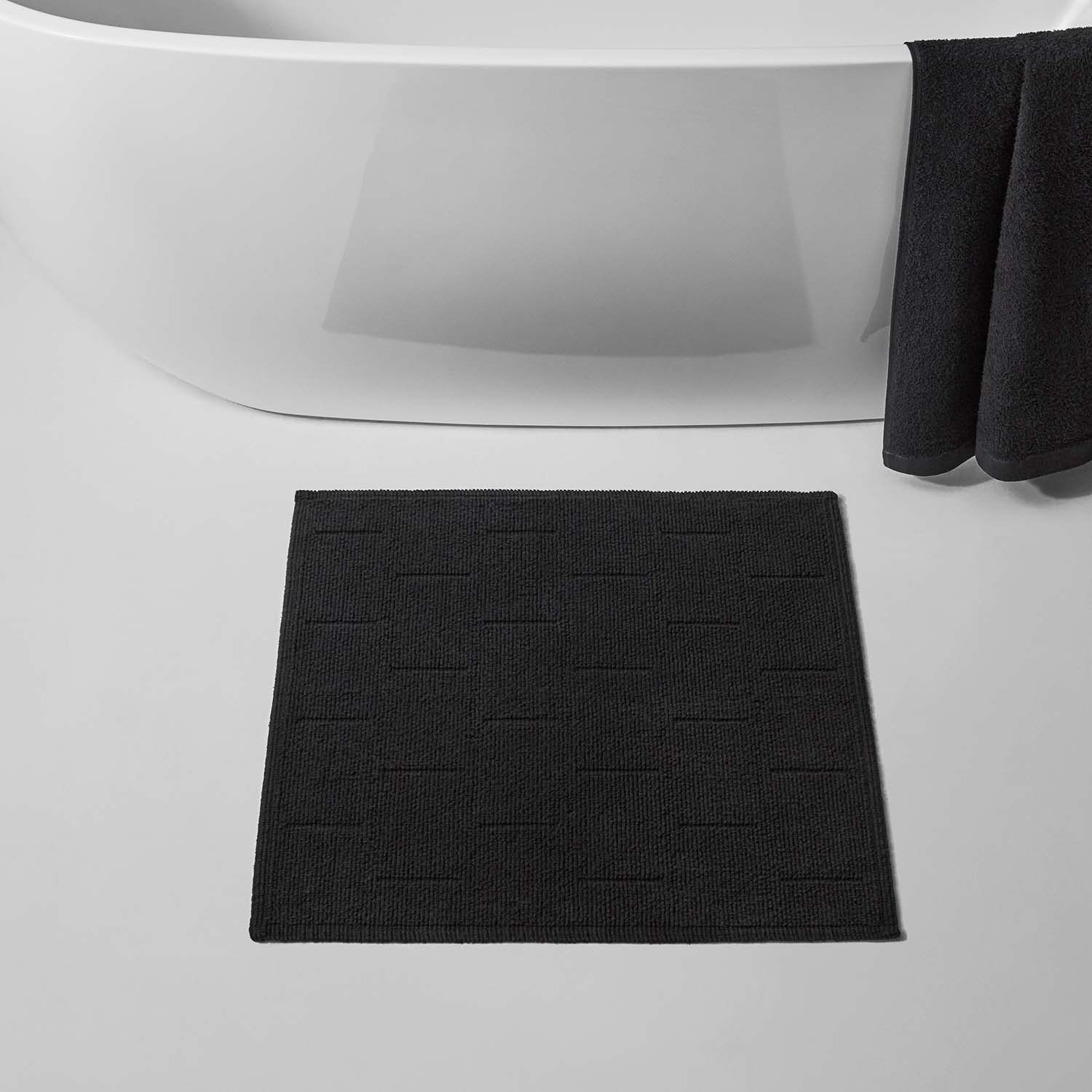 Wabi Sabi black tub mat in a modern bathroom, showcasing minimalist Japanese design and natural textures.