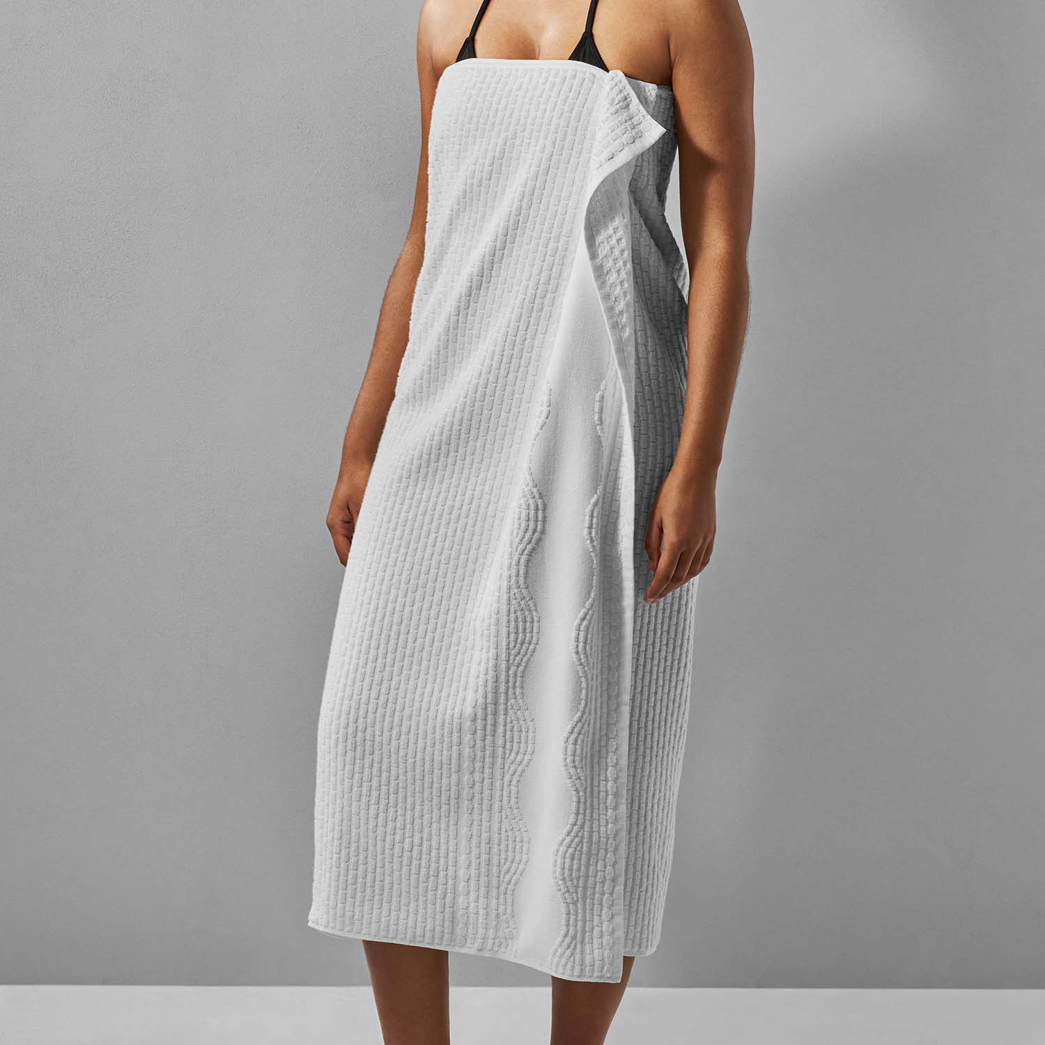 Wave Towel in white cotton, featuring a textured design, perfect for poolside or beach relaxation.