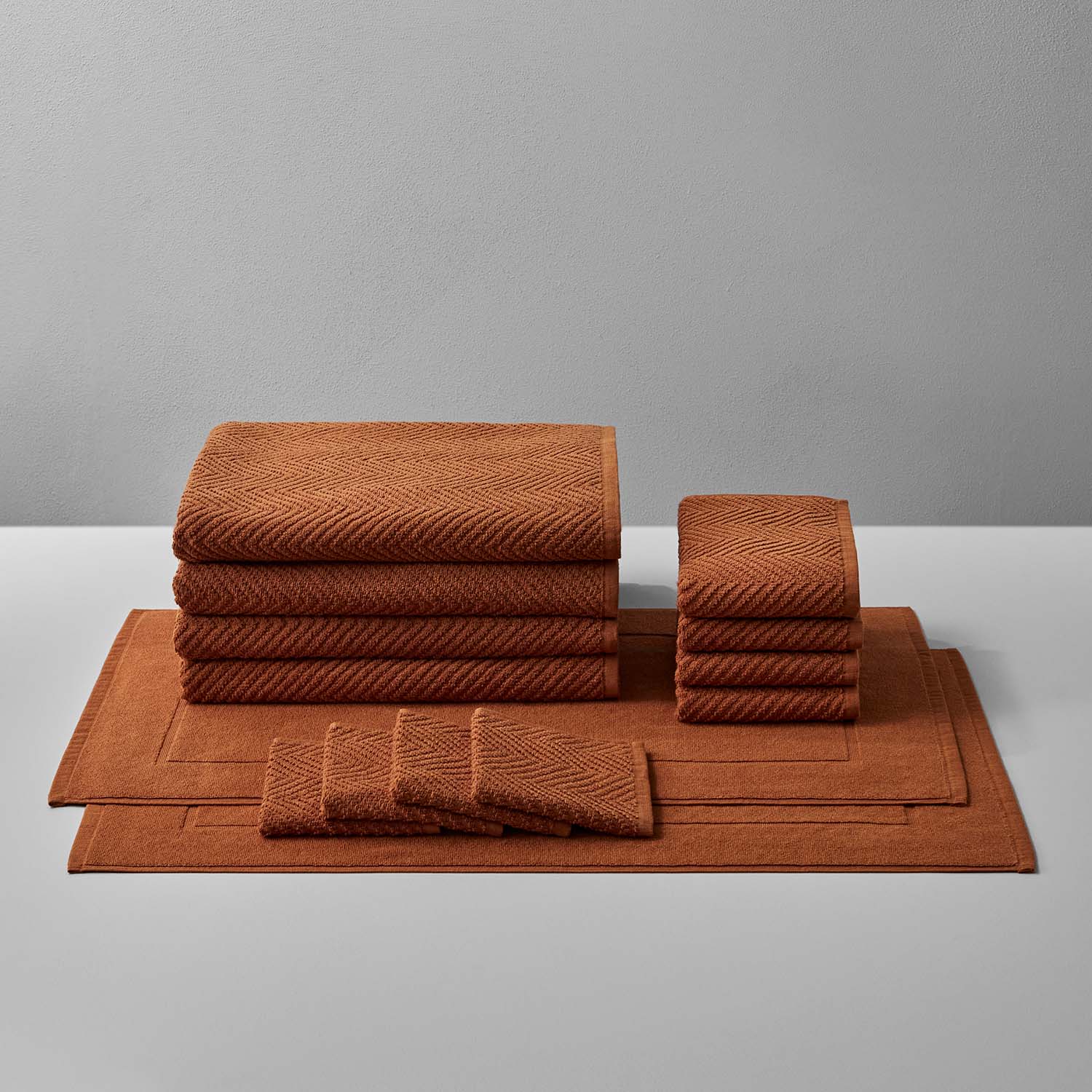 Treatment Bath Bundle Clay featuring rich, warm brown towels and mats for ultimate comfort and relaxation.