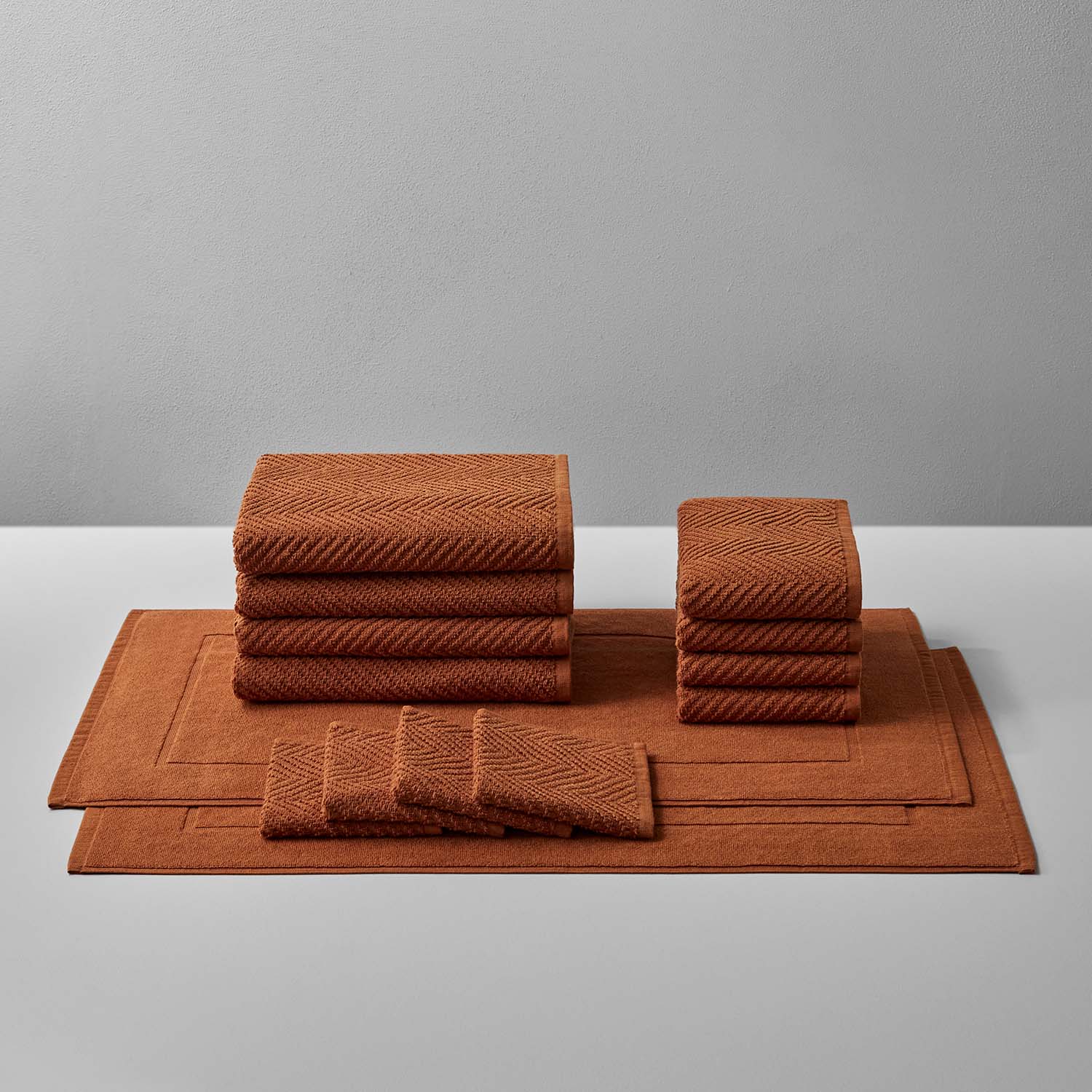 Earthy-toned treatment bath bundle featuring soft, durable towels and mats for ultimate comfort and relaxation.