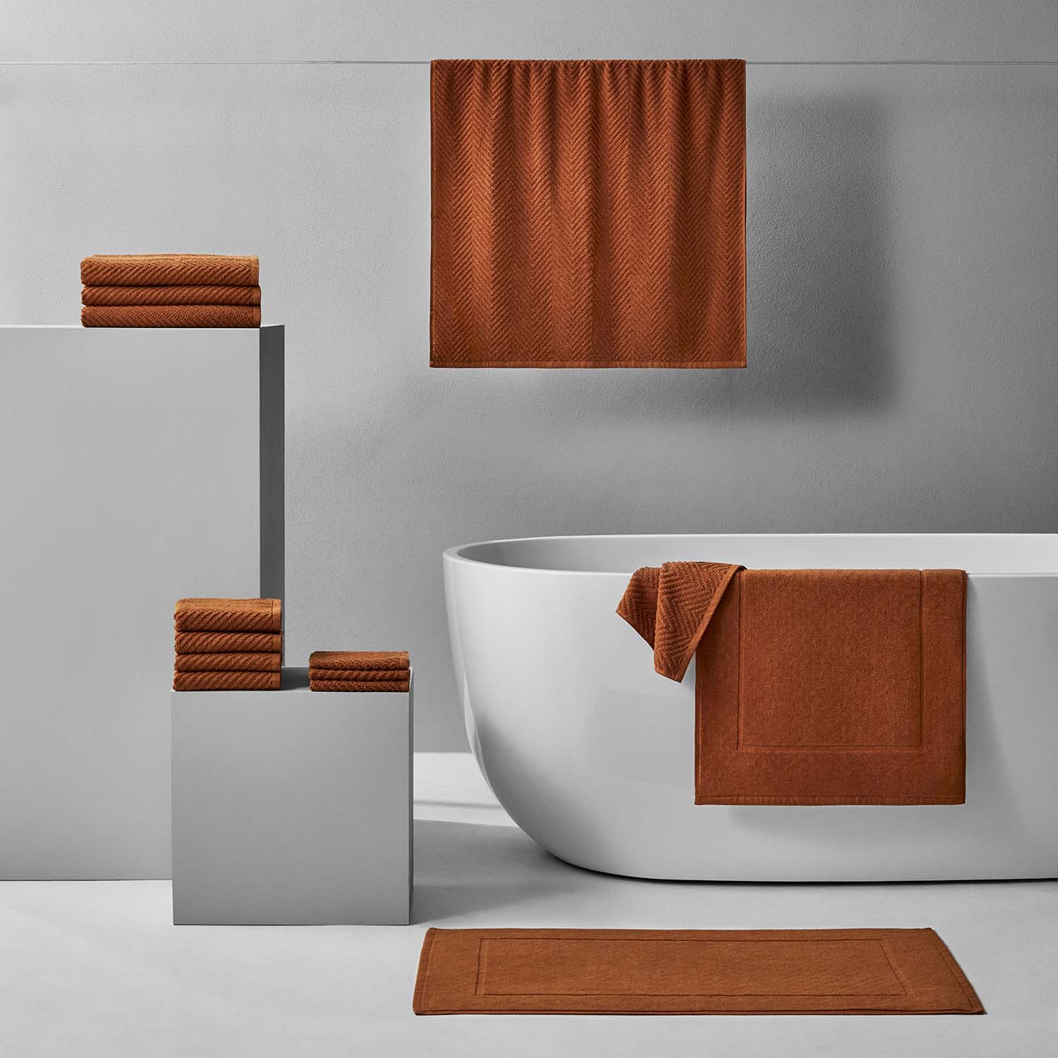 Treatment Bath Bundle Clay featuring warm brown towels and textured designs on modern display for relaxation and care.