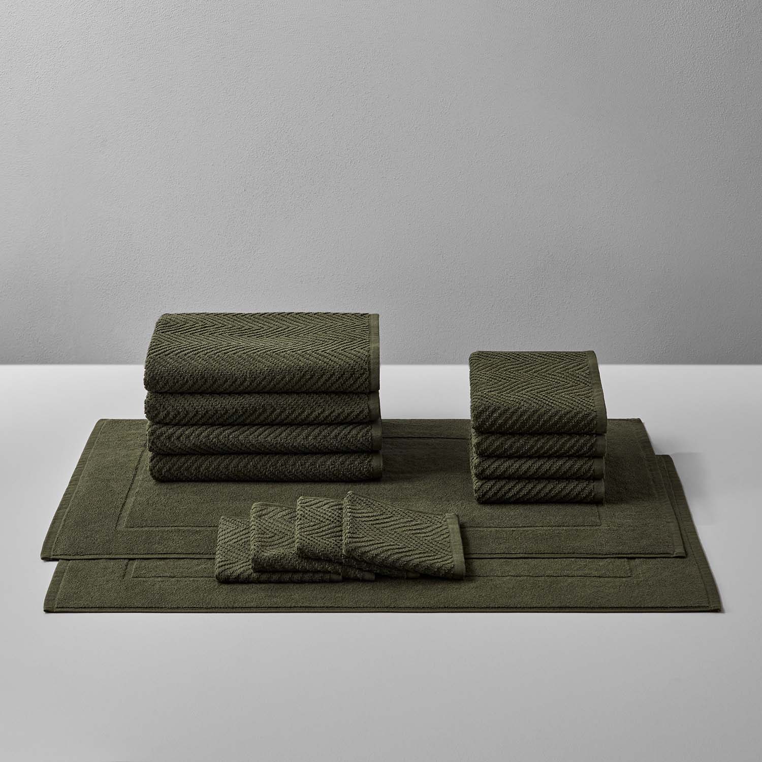Treatment Bath Bundle in olive green, featuring soft, durable towels and mats designed for comfort and relaxation.