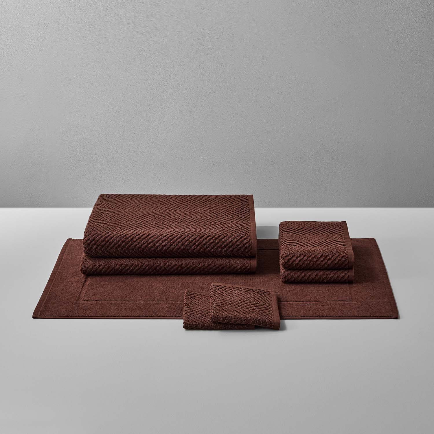 Treatment Bath Bundle Bruno featuring soft, earthen-toned towels and mats, perfect for relaxation and comfort.