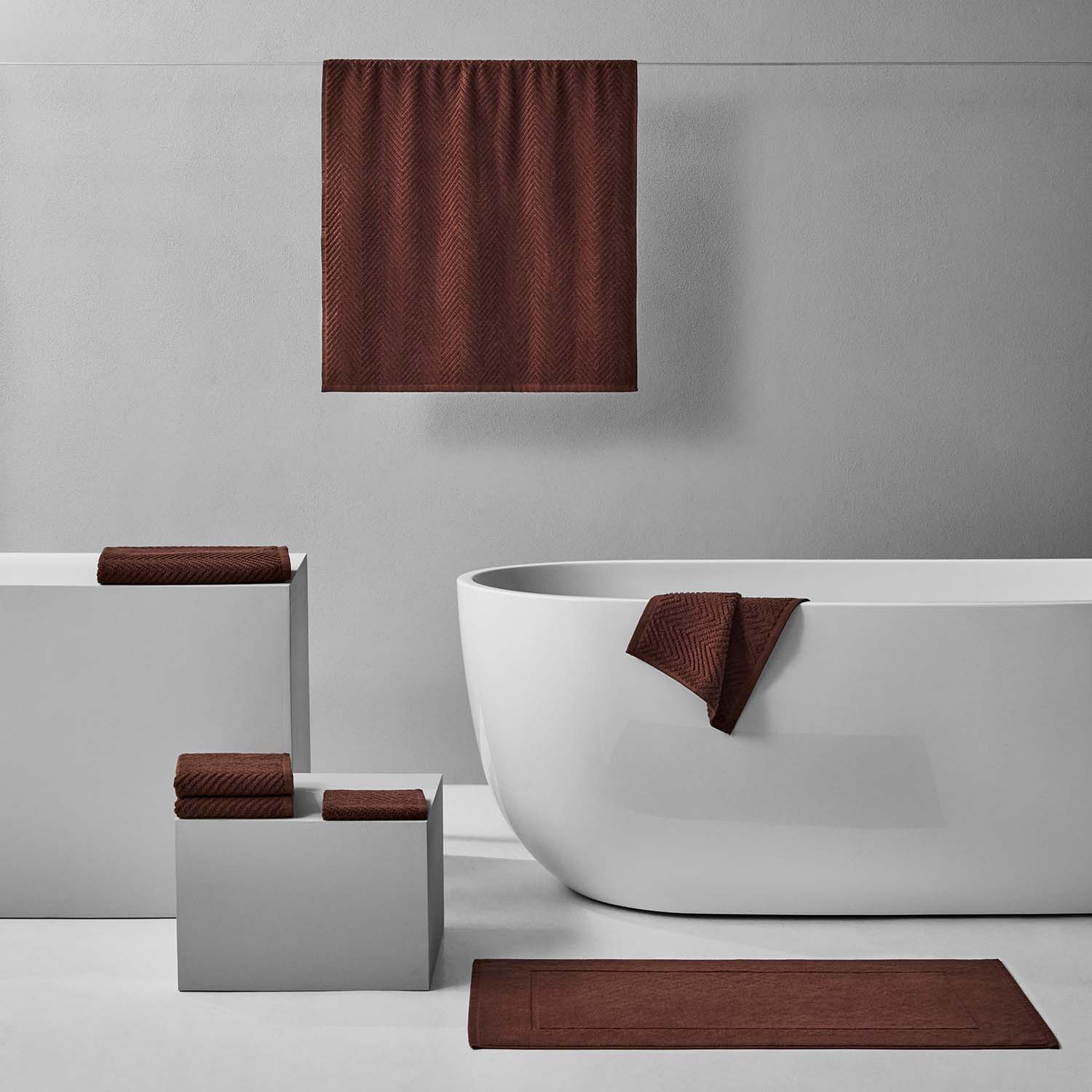 Luxurious Treatment Bath Bundle Bruno in warm, earthen tones featuring soft textured towels and modern bathroom accessories.