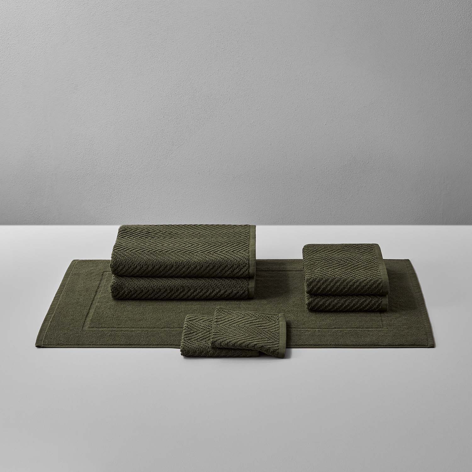 Olive Treatment Bath Bundle featuring textured towels and mats in warm, earthen tones for ultimate relaxation.