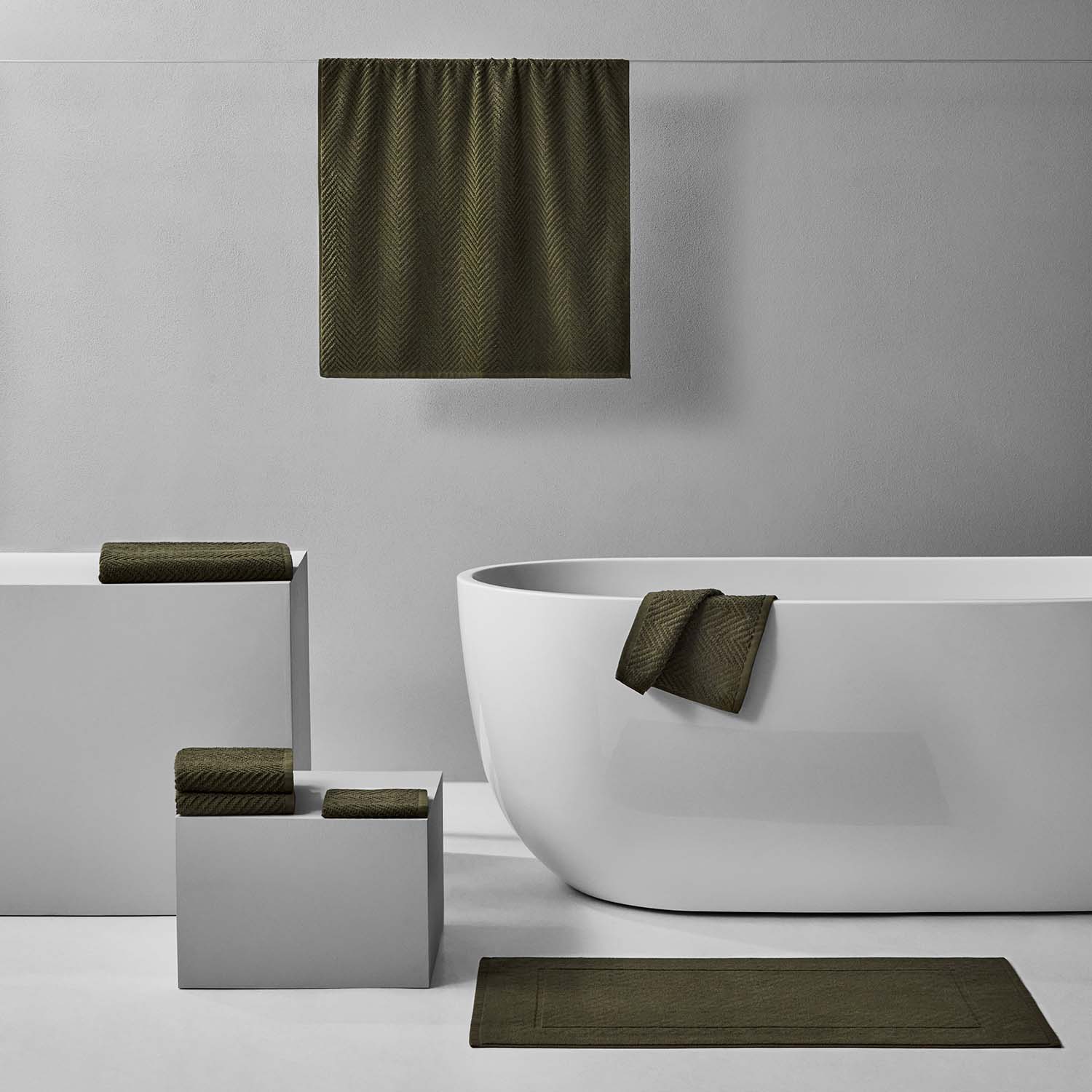 Stylish Treatment Bath Bundle in olive featuring towels and bath mat for a cozy, relaxing bathroom aesthetic.