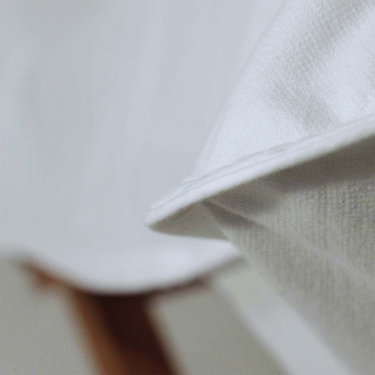 Close-up of the SOL Lounge Chair Cover in white, showcasing its textured fabric and elegant finish.