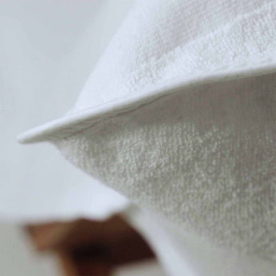 Close-up of a soft, white fabric showing the texture of the Lounge Chair Cover, ideal for poolside comfort.